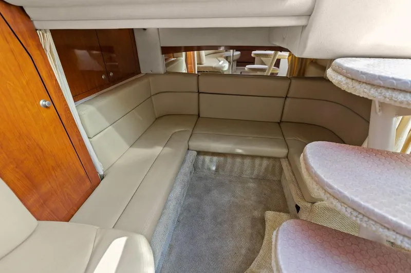 Slide: The Image of Interior of 2006 Sea Ray 320 Sundancer with beige seating and wooden accents. - 29