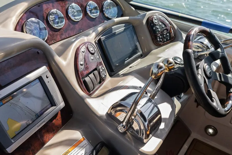 Slide: The Image of 2006 Sea Ray 320 Sundancer helm with navigation and control systems. - 3