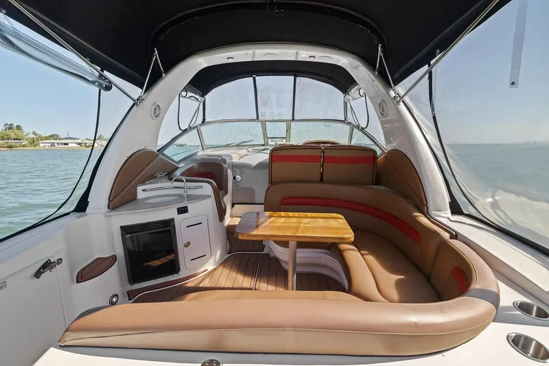 Slide: The Image of 2006 Sea Ray 320 Sundancer boat interior with seating and kitchenette. - 9