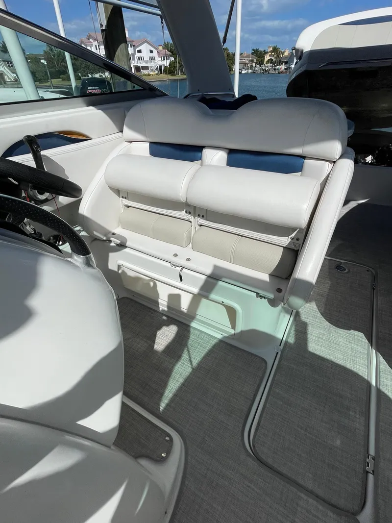 Slide: The Image of 2009 Chaparral 276 SSX boat interior with white leather seating and modern design. - 11