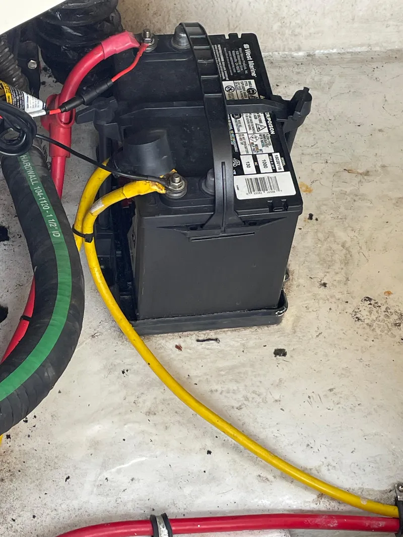 Slide: The Image of Battery compartment of a 2009 Chaparral 276 SSX boat with connected cables. - 14