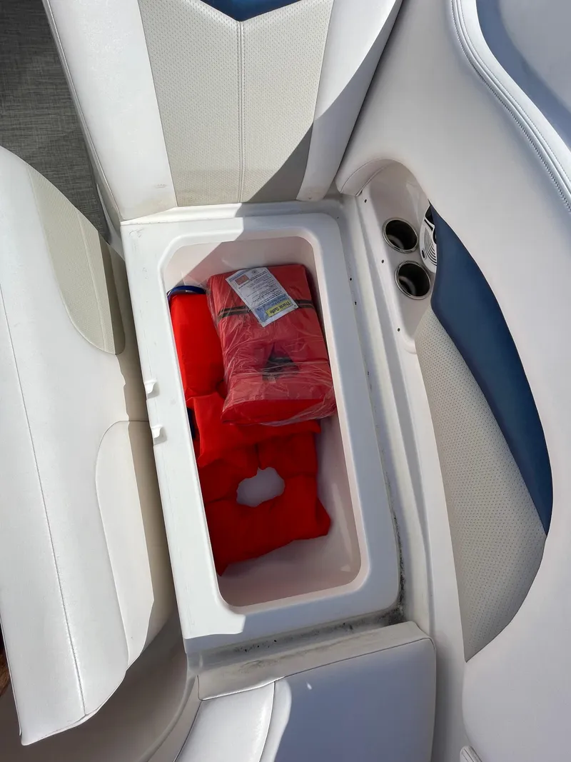 Slide: The Image of Storage compartment with life jackets on a 2009 Chaparral 276 SSX boat. - 16