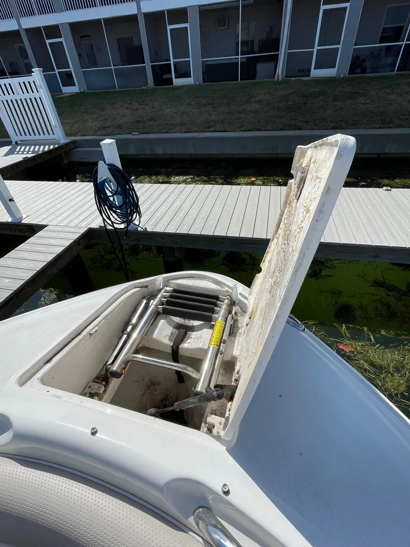 Slide: The Image of Open storage compartment on a 2009 Chaparral 276 SSX boat docked near a canal. - 17