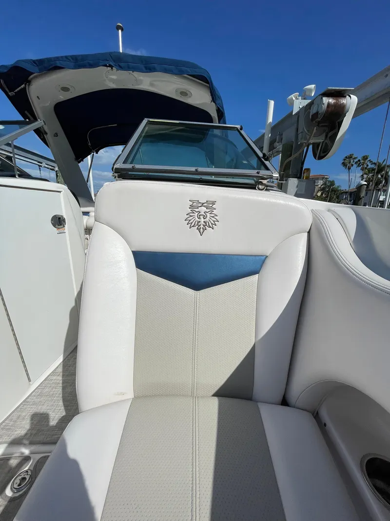 Slide: The Image of 2009 Chaparral 276 SSX boat interior with white and blue seating. - 25