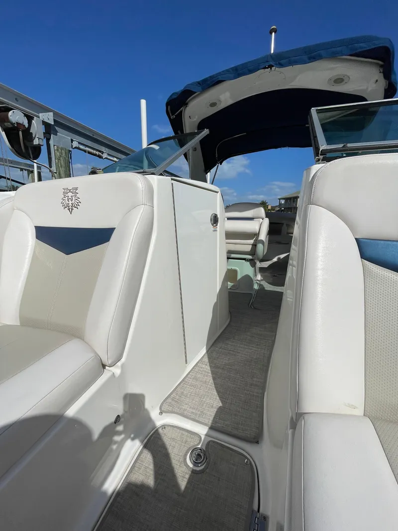 Slide: The Image of 2009 Chaparral 276 SSX boat interior with white seating and blue accents. - 26