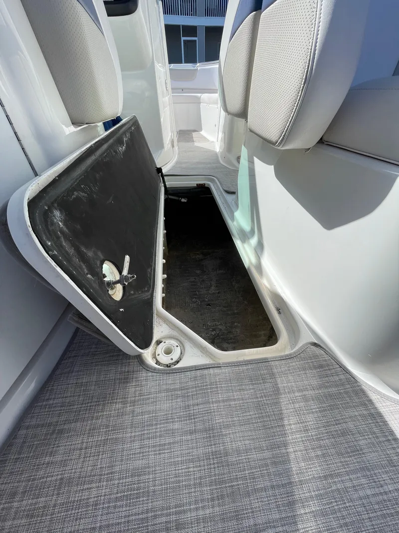 Slide: The Image of 2009 Chaparral 276 SSX boat interior storage compartment with open hatch. - 27