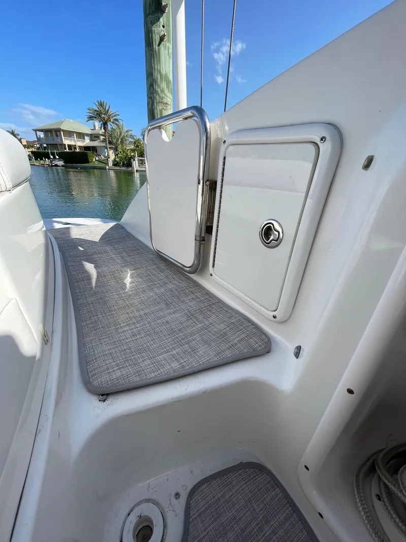 Slide: The Image of 2009 Chaparral 276 SSX boat interior with storage compartments and cushioned seating. - 28