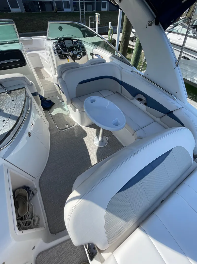Slide: The Image of 2009 Chaparral 276 SSX boat interior with white seating and control panel. - 3
