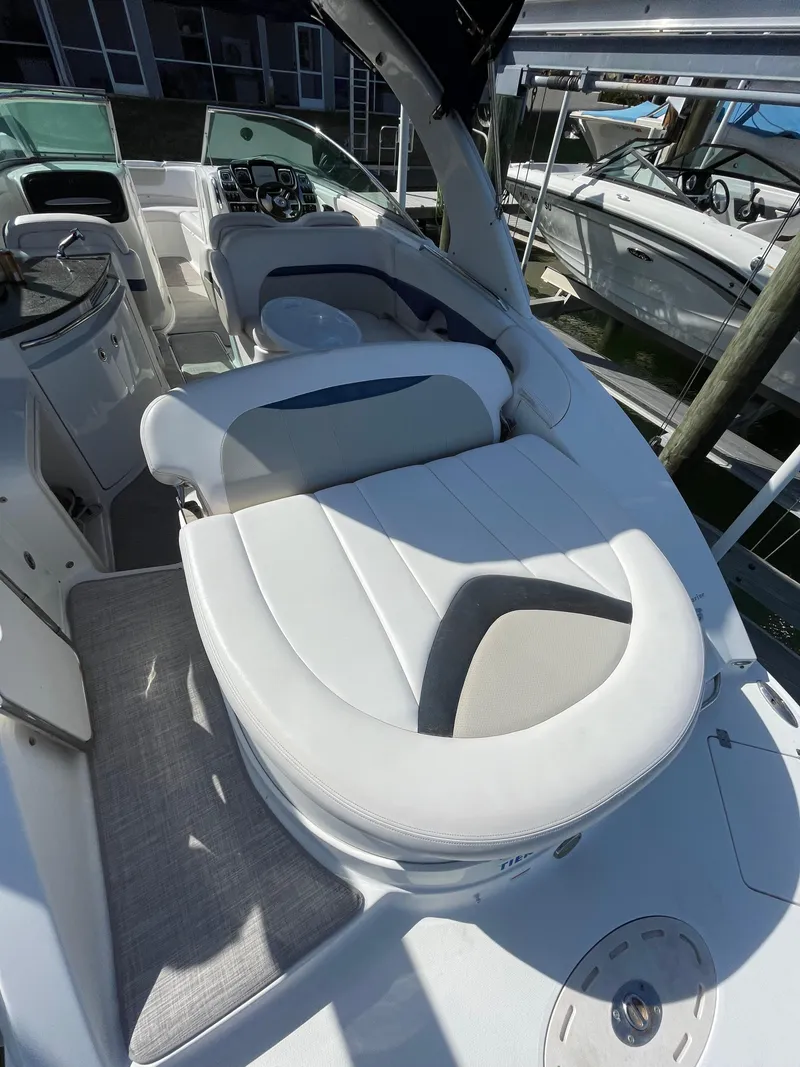 Slide: The Image of 2009 Chaparral 276 SSX boat interior with white seating and dashboard. - 30