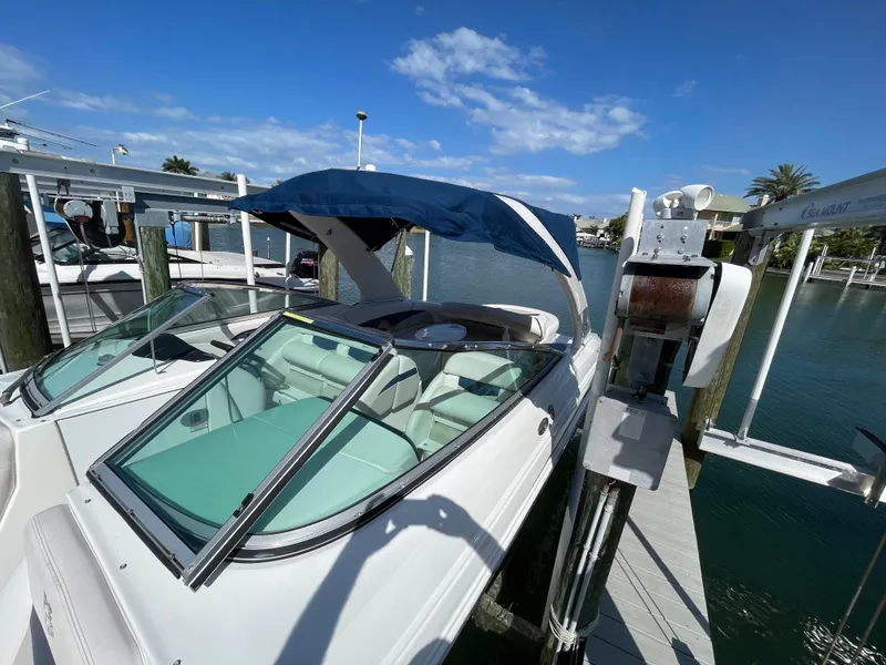 Slide: The Image of 2009 Chaparral 276 SSX boat docked with blue canopy on a sunny day. - 35