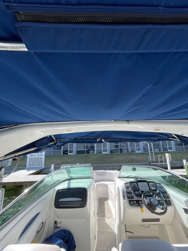 Slide: The Image of 2009 Chaparral 276 SSX boat interior with blue canopy and control panel. - 41