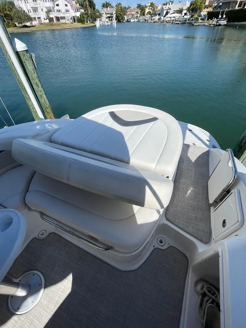 Slide: The Image of 2009 Chaparral 276 SSX boat with white seating and waterfront view. - 7