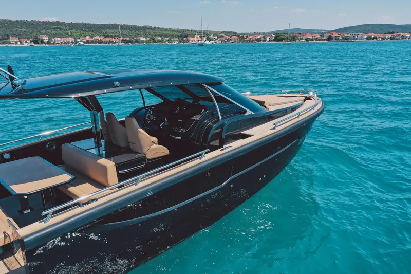 Slide: The Image of 2025 Focus Forza 37 luxury yacht cruising on clear blue waters. - 12