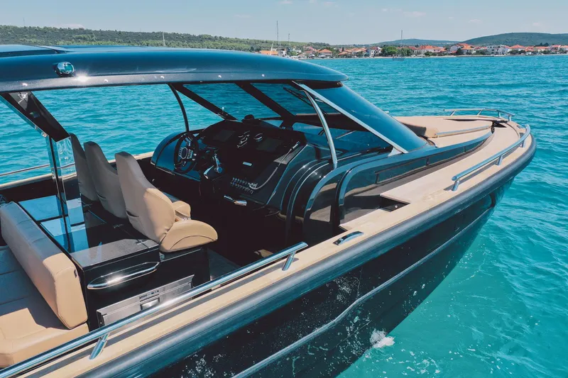 Slide: The Image of 2025 Focus Forza 37 luxury boat cruising on clear blue water. - 13