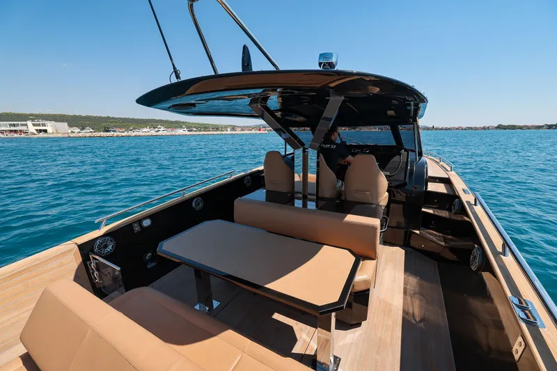 Slide: The Image of Luxury 2025 Focus Forza 37 boat with sleek design and spacious seating on open water. - 14