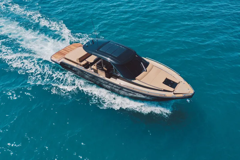 Slide: The Image of 2025 Focus Forza 37 boat cruising on clear blue water. - 4