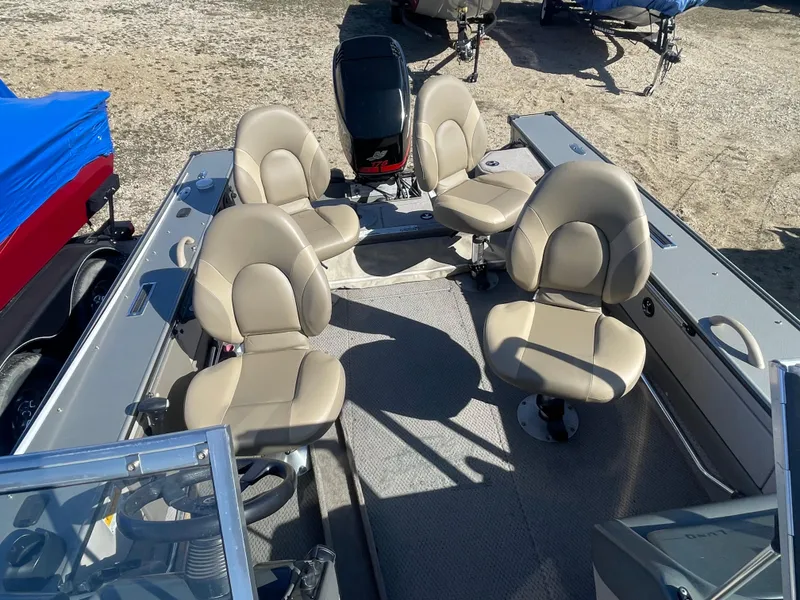 Slide: The Image of 2001 Lund 1900 Pro-V IFS boat with four beige seats and motor. - 12