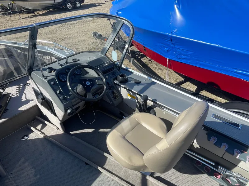 Slide: The Image of 2001 Lund 1900 Pro-V IFS boat interior with steering wheel and captain's chair. - 5