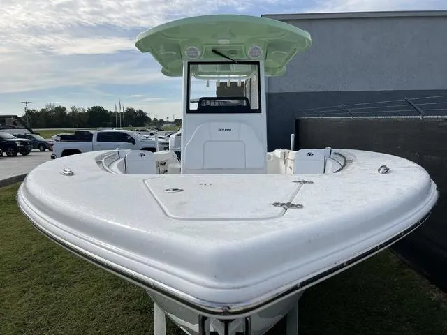 Slide: The Image of 2024 Sea Pro 259 Sport boat, front view, parked on grass. - 4