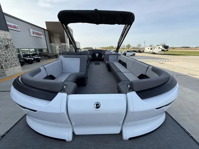 Slide: The Image of 2024 Manitou Cruise 22 Max Bench V-Toon pontoon boat with spacious seating and canopy. - 5