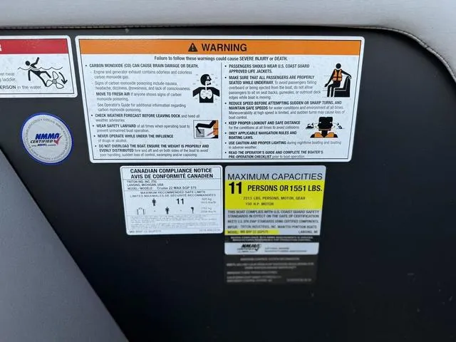 Slide: The Image of Warning labels on 2024 Manitou Cruise 22 Max Bench V-Toon, maximum capacity 11 persons or 1551 lbs. - 8