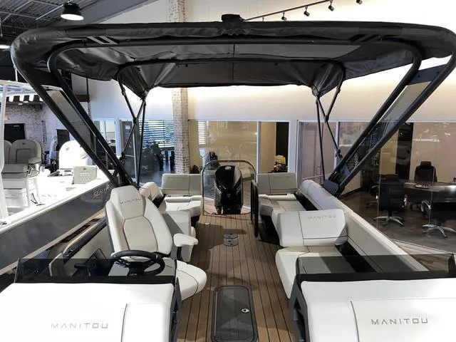 Slide: The Image of 2024 Manitou Explore 26 Switchback Single Engine V-Toon boat with spacious seating and canopy. - 5