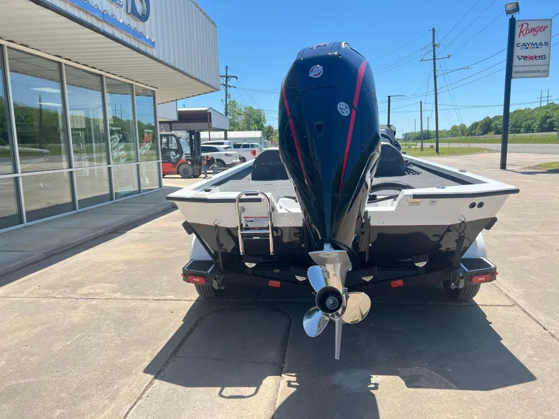 Slide: The Image of 2024 Vexus AVX 2080 boat with outboard motor, rear view, parked outside dealership. - 3