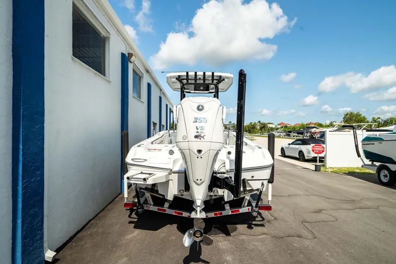 Slide: The Image of 2025 Crevalle 26 HBW boat with a 350 V8 engine parked outdoors. - 10