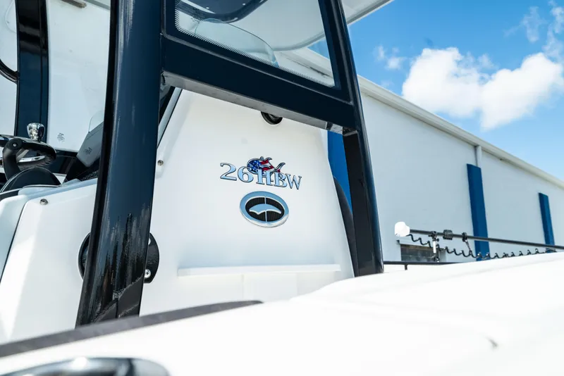 Slide: The Image of 2025 Crevalle 26 HBW boat exterior with logo and clear sky background. - 13