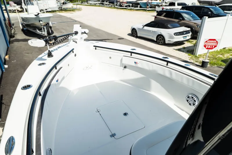 Slide: The Image of 2025 Crevalle 26 HBW boat bow area with storage compartments and seating. - 16