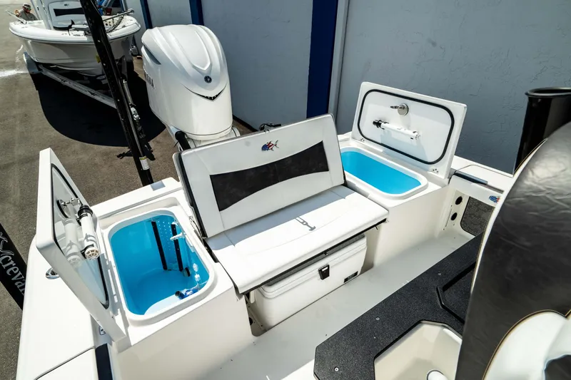 Slide: The Image of 2025 Crevalle 26 HBW boat with open storage compartments and seating. - 2