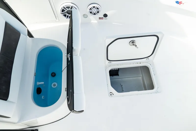 Slide: The Image of 2025 Crevalle 26 HBW boat deck with storage compartments and seating. - 21