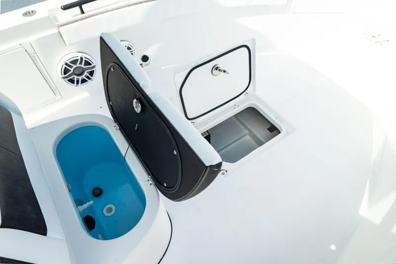 Slide: The Image of Crevalle 26 HBW 2025 boat deck with storage compartments and livewell. - 23