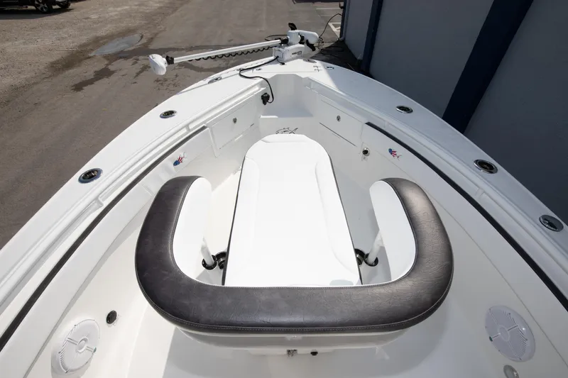 Slide: The Image of 2025 Crevalle 26 HBW boat bow seating area with cushioned seats and storage compartments. - 26