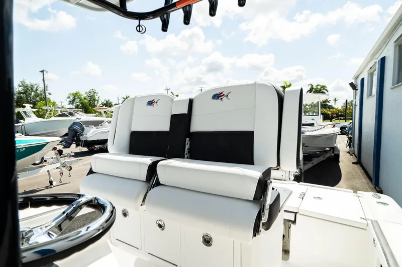 Slide: The Image of 2025 Crevalle 26 HBW boat with dual white and black cushioned seats. - 27