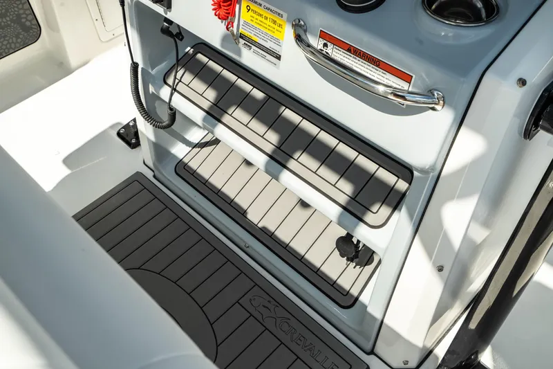 Slide: The Image of 2025 Crevalle 26 HBW boat console with non-slip flooring and safety features. - 28