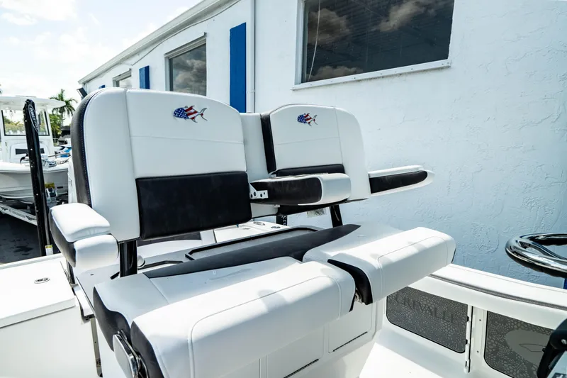 Slide: The Image of 2025 Crevalle 26 HBW boat with dual white and black captain's chairs. - 34