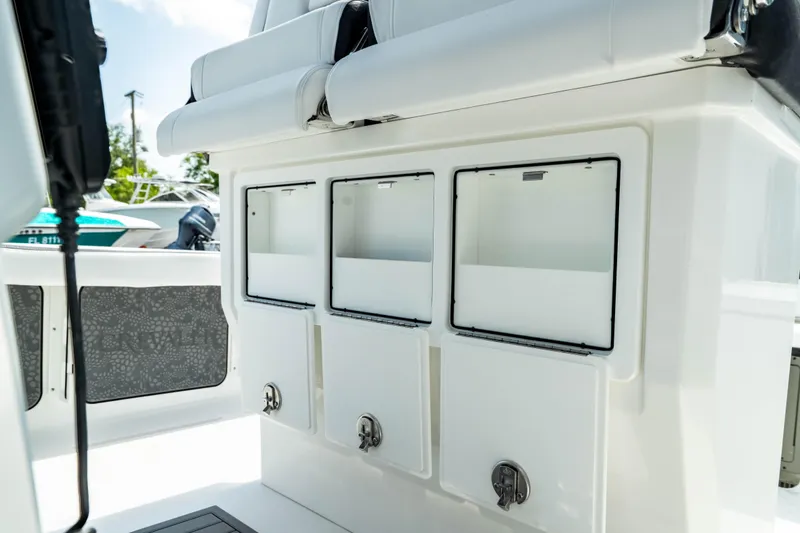 Slide: The Image of 2025 Crevalle 26 HBW boat storage compartments and seating area. - 35