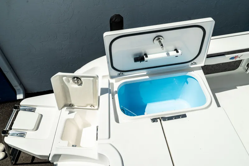 Slide: The Image of 2025 Crevalle 26 HBW boat with open storage compartments and livewell. - 36
