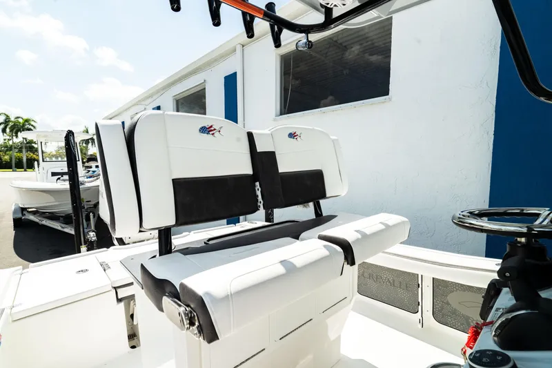 Slide: The Image of 2025 Crevalle 26 HBW boat interior with white and black seating. - 6