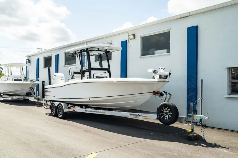 Slide: The Image of 2025 Crevalle 26 HBW boat on a trailer outside a building. - 9