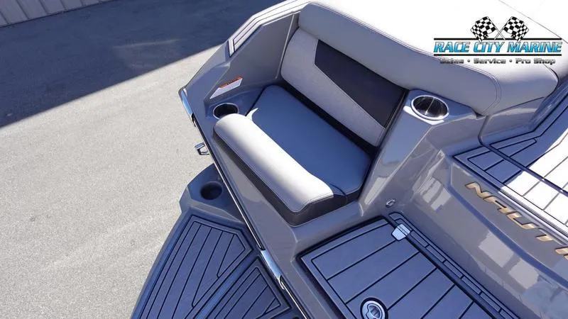 Slide: The Image of 2021 Nautique Super Air Nautique G25 boat interior with seating and cup holders. - 13