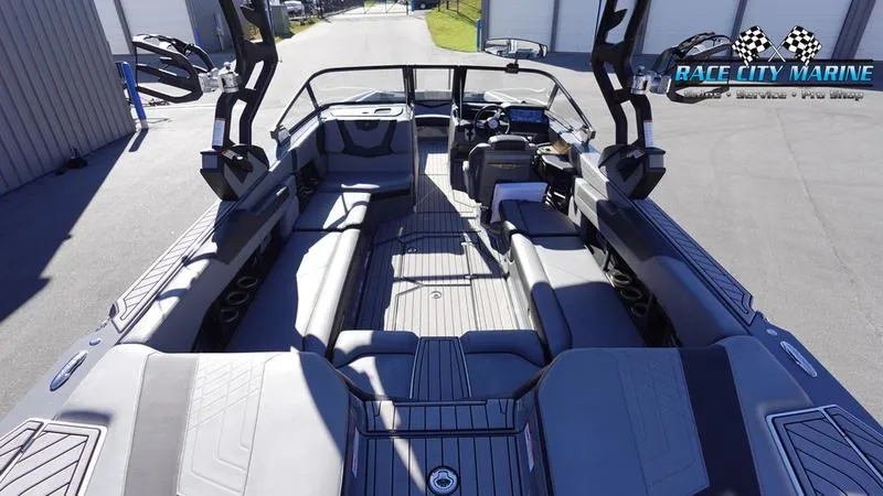Slide: The Image of 2021 Nautique Super Air Nautique G25 boat interior with spacious seating and modern design. - 16