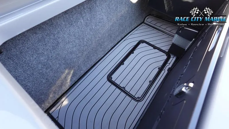 Slide: The Image of 2021 Nautique Super Air Nautique G25 storage compartment with Race City Marine branding. - 19