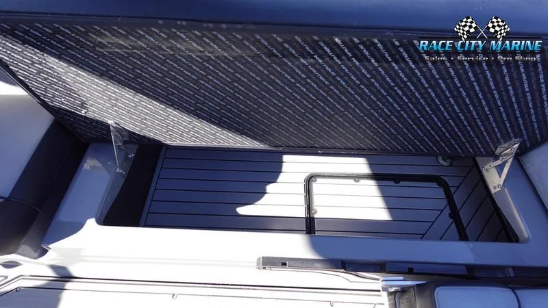 Slide: The Image of 2021 Nautique Super Air Nautique G25 storage compartment, Race City Marine branding. - 26