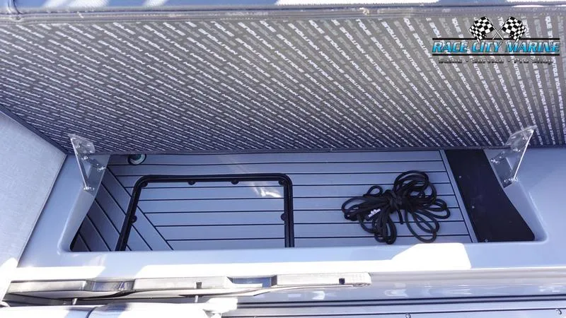 Slide: The Image of 2021 Nautique Super Air Nautique G25 storage compartment with rope, Race City Marine logo. - 27