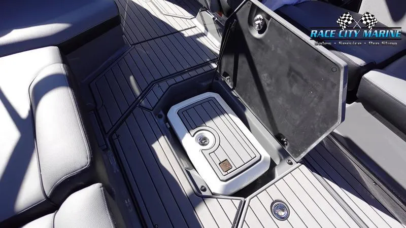 Slide: The Image of 2021 Nautique Super Air Nautique G25 boat interior with open storage compartment. - 28