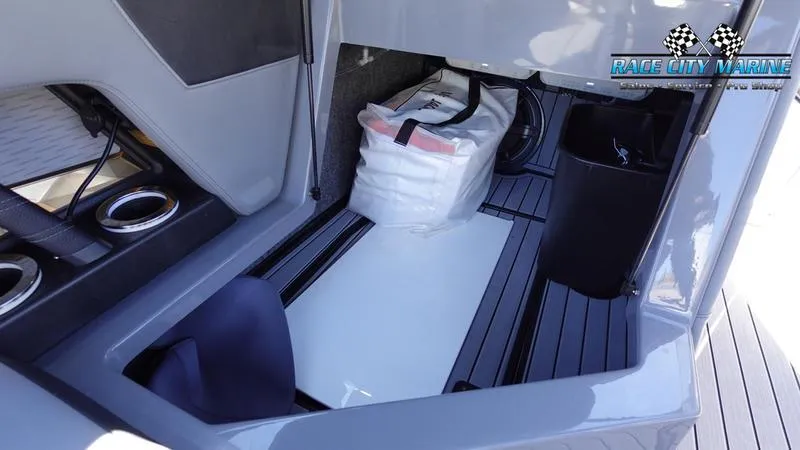 Slide: The Image of 2021 Nautique Super Air Nautique G25 storage compartment with life jackets and accessories. - 30