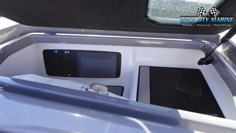 Slide: The Image of 2021 Nautique Super Air Nautique G25 interior storage compartment with control panel. - 31