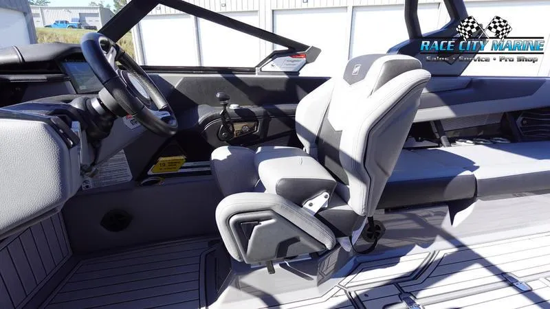 Slide: The Image of 2021 Nautique Super Air Nautique G25 interior with modern helm and seating. - 32